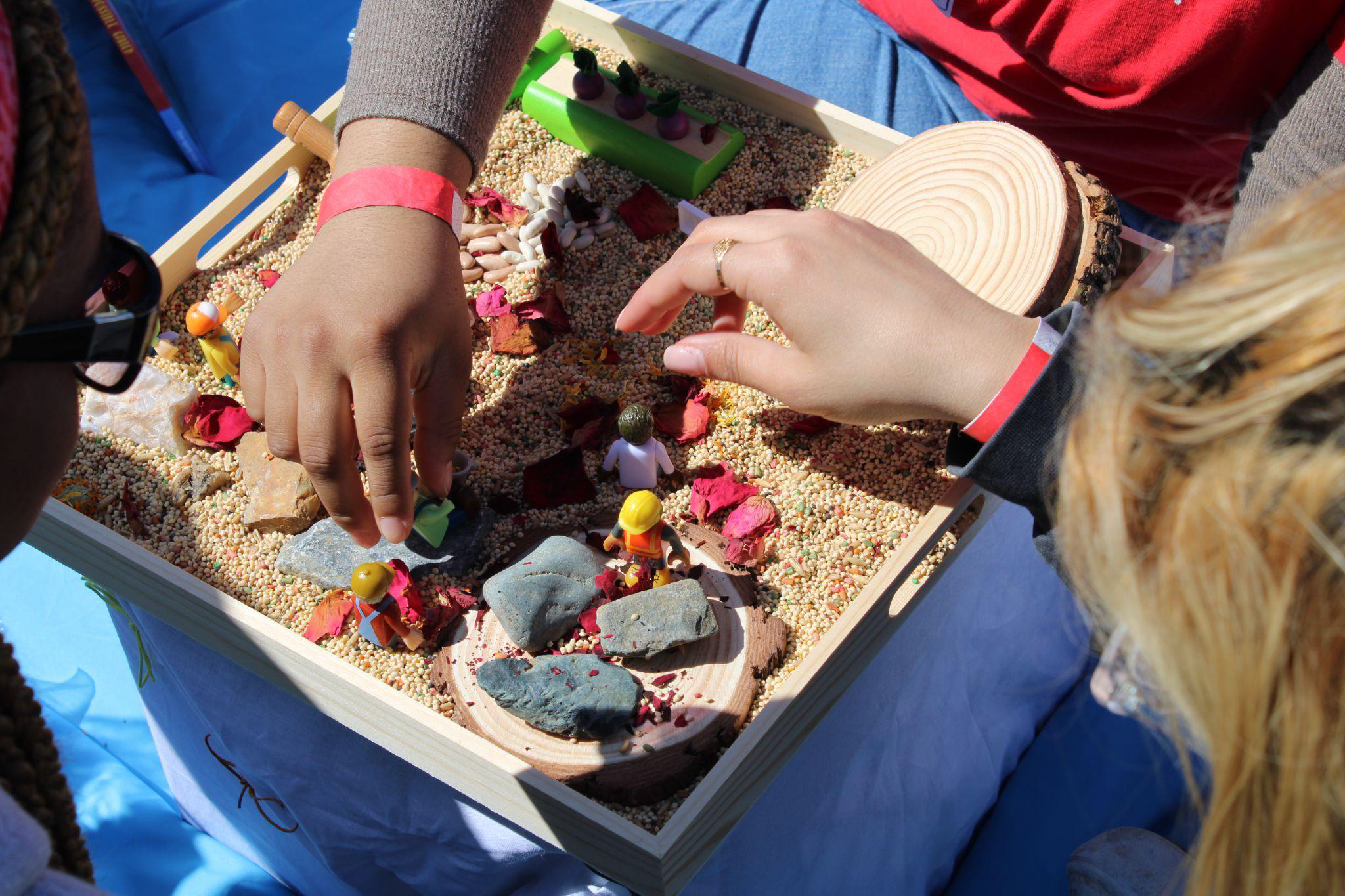 Hands collecting some rocks