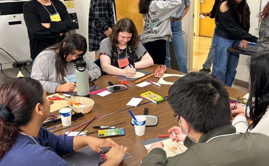 Students crafting around a table.